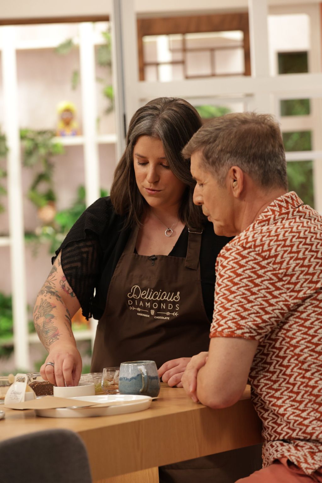 João Baião tastes a bonbon beside Chef Joana Marinho