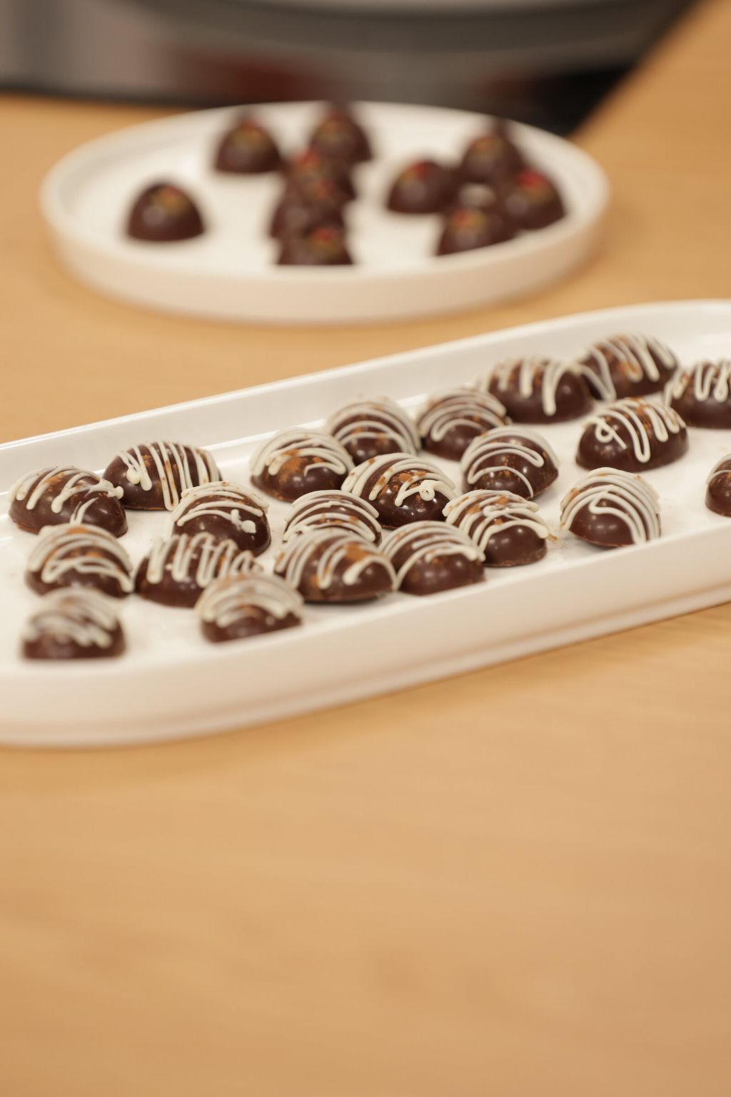 Delicious Diamonds bonbons on white platters, on the Casa Feliz counter